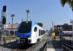 Metrolink Arrow Stadler DMU Car # 3404 crosses Orange Avenue at grade just as it arrives into Redlands Downtown Station 